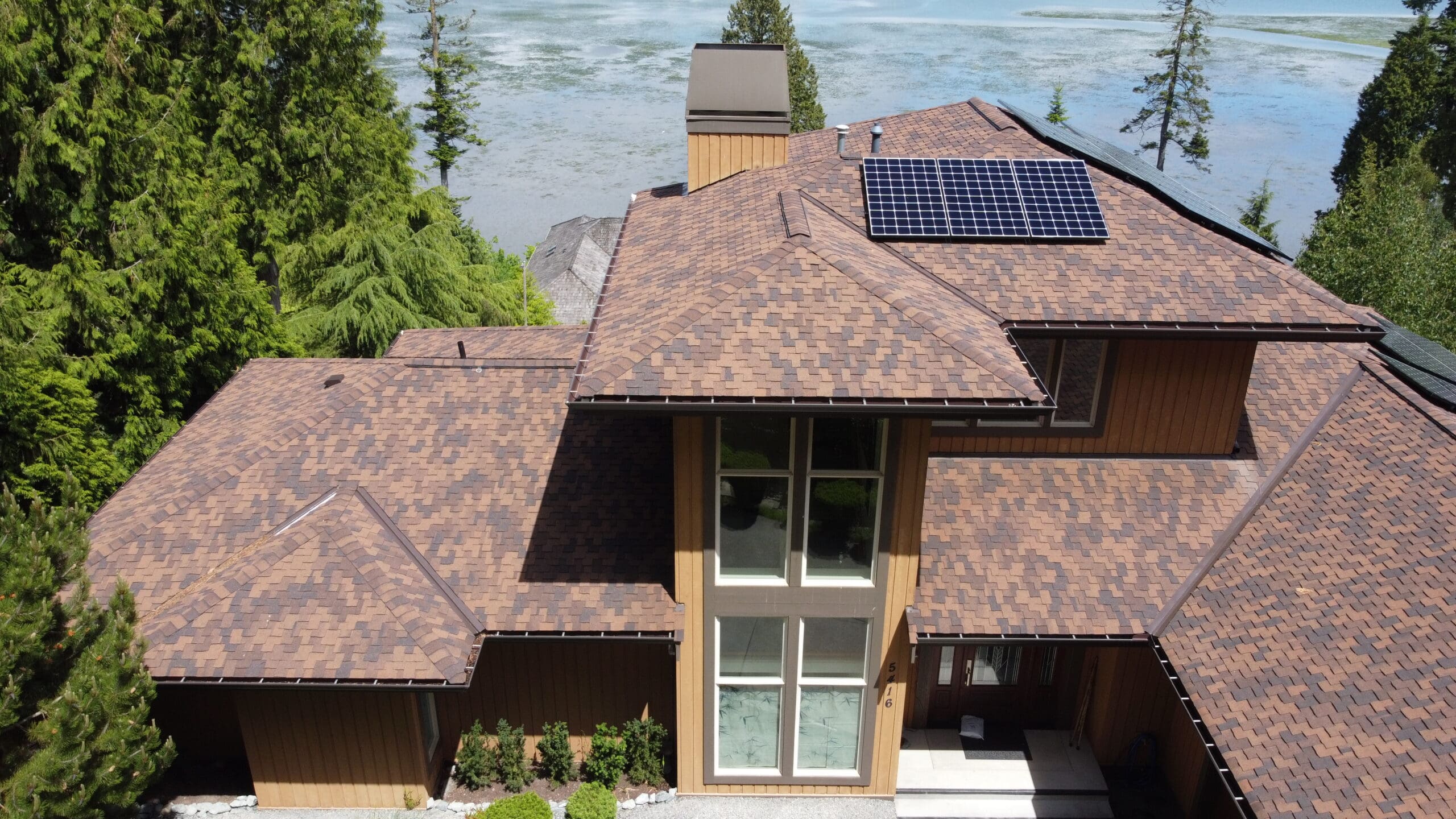 Aerial view of a metal roof installation in the Pacific Northwest